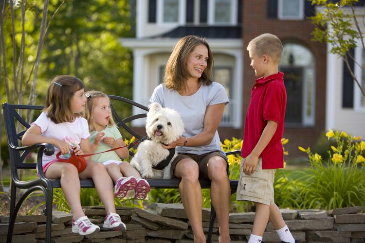 family on bench with dog